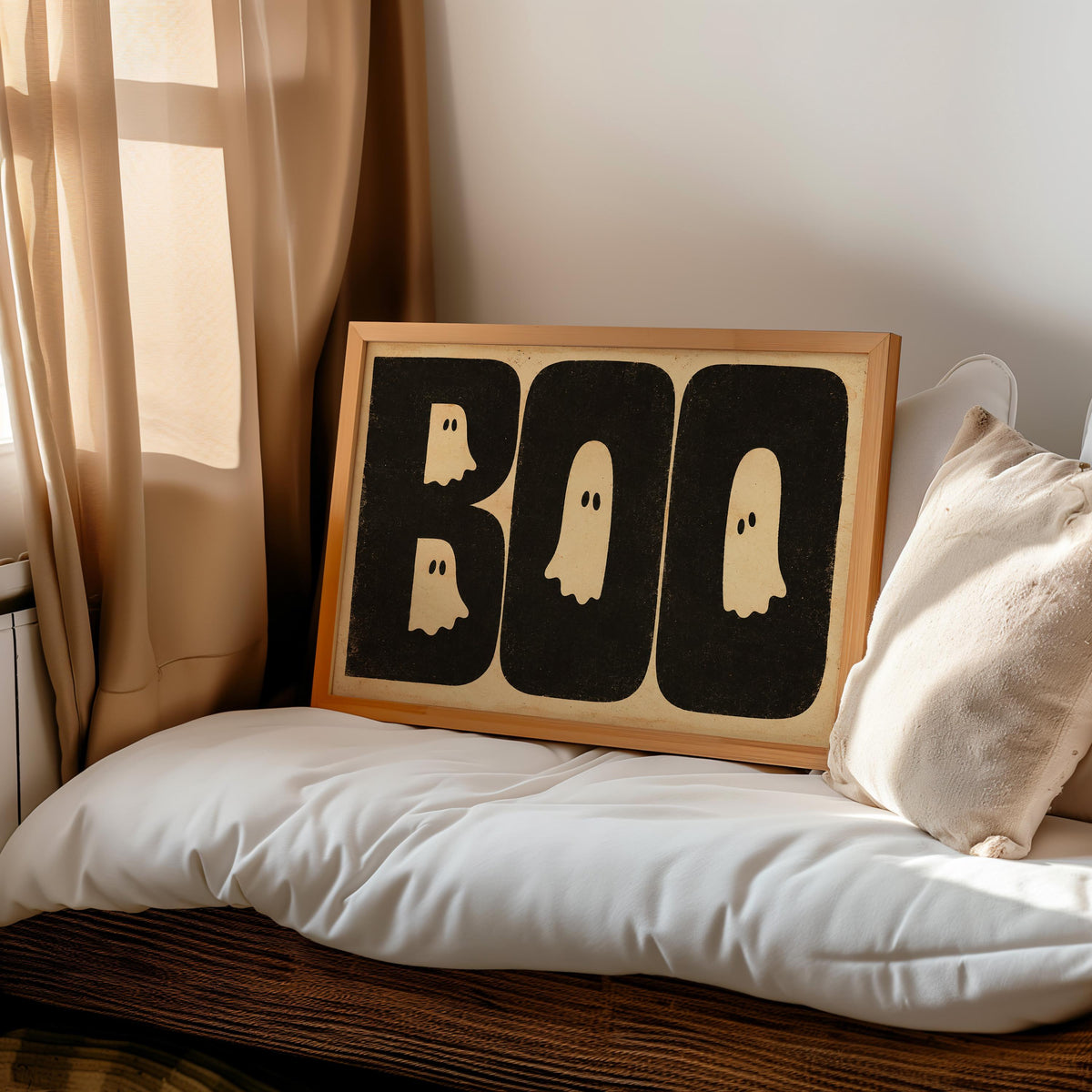 Halloween BOO wall art propped on a cozy bed nook, distressed black lettering with cream ghost shapes, retro Halloween poster