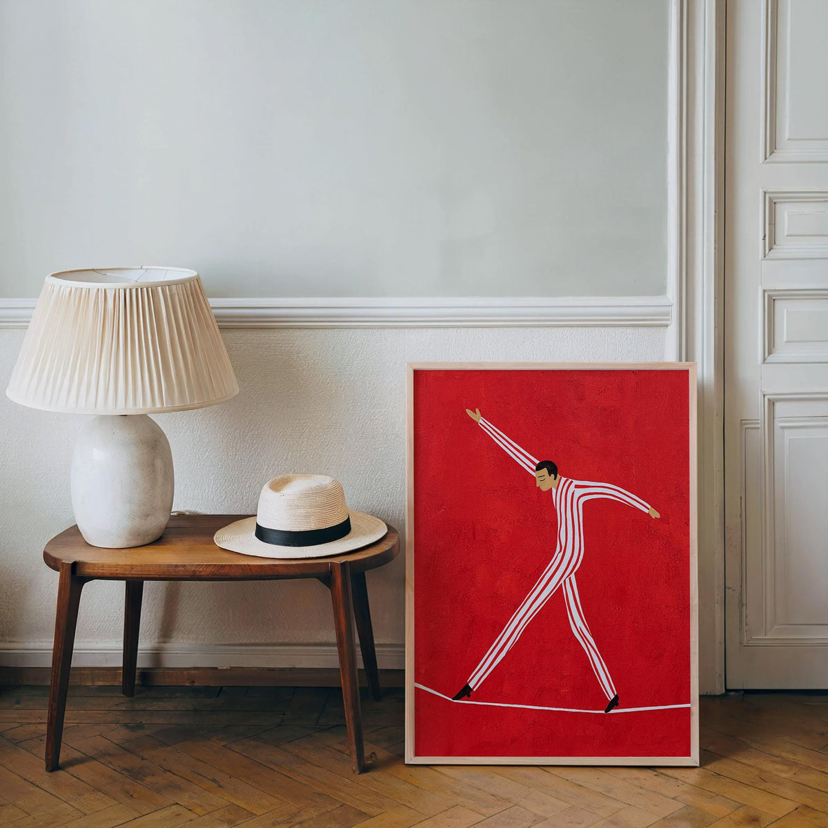 Small console with lamp and tightrope walker wall art leaning below, kids room wall art, playful retro