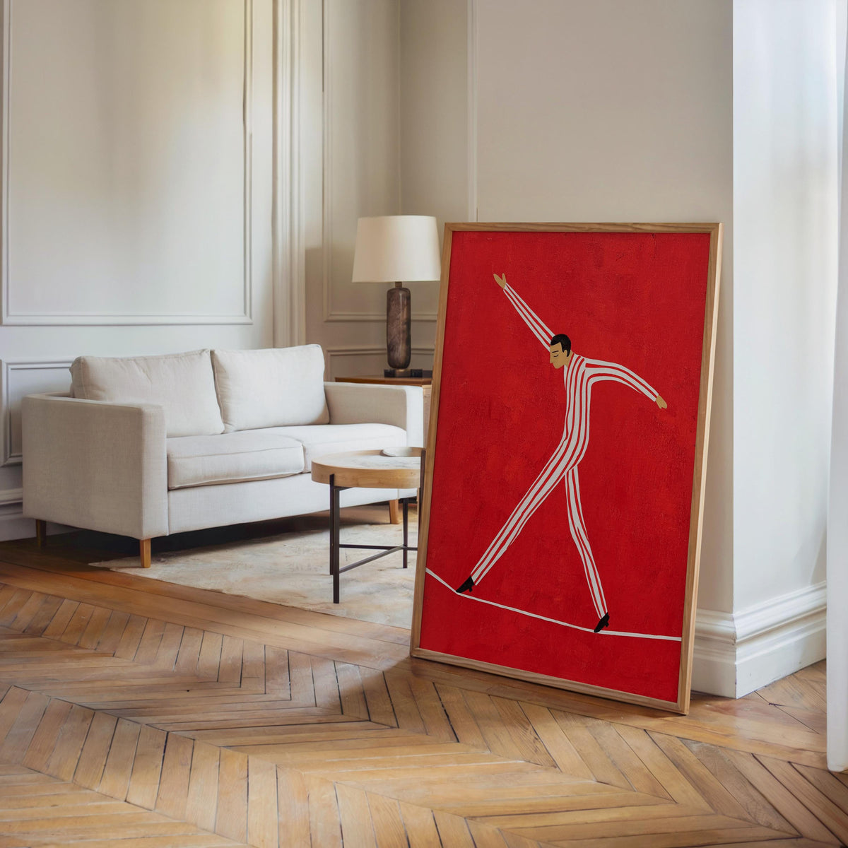Tall framed tightrope walker wall art beside a couch, maximalist red circus art, retro acrobat motif