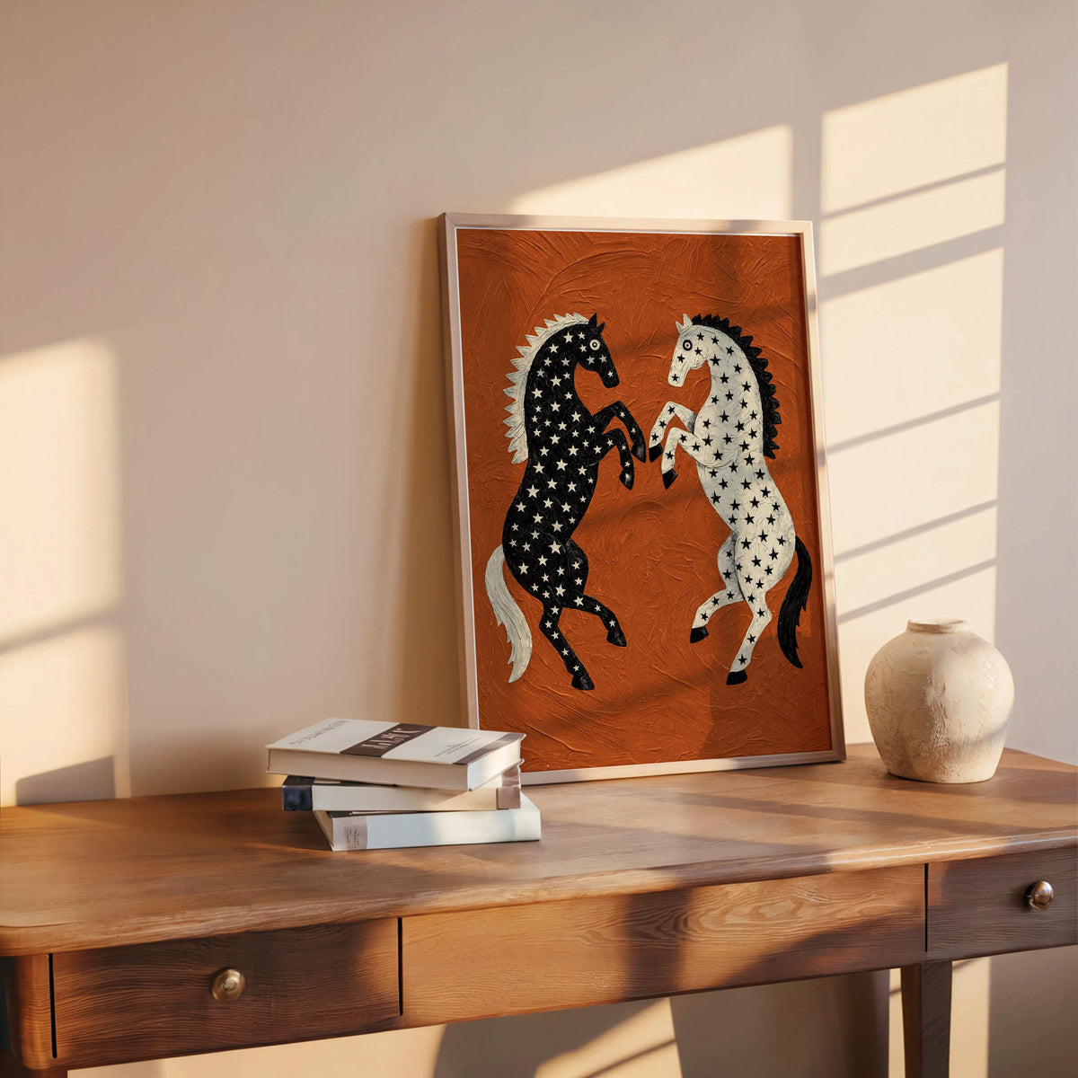 Western horse wall art on a wooden console with pottery and sunlight slats, textured rust orange print featuring contrasting star-decorated horses