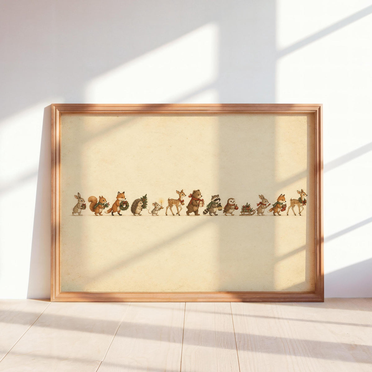 Framed woodland animal Christmas print leaning against wall, sunlit cream background, wooden frame
