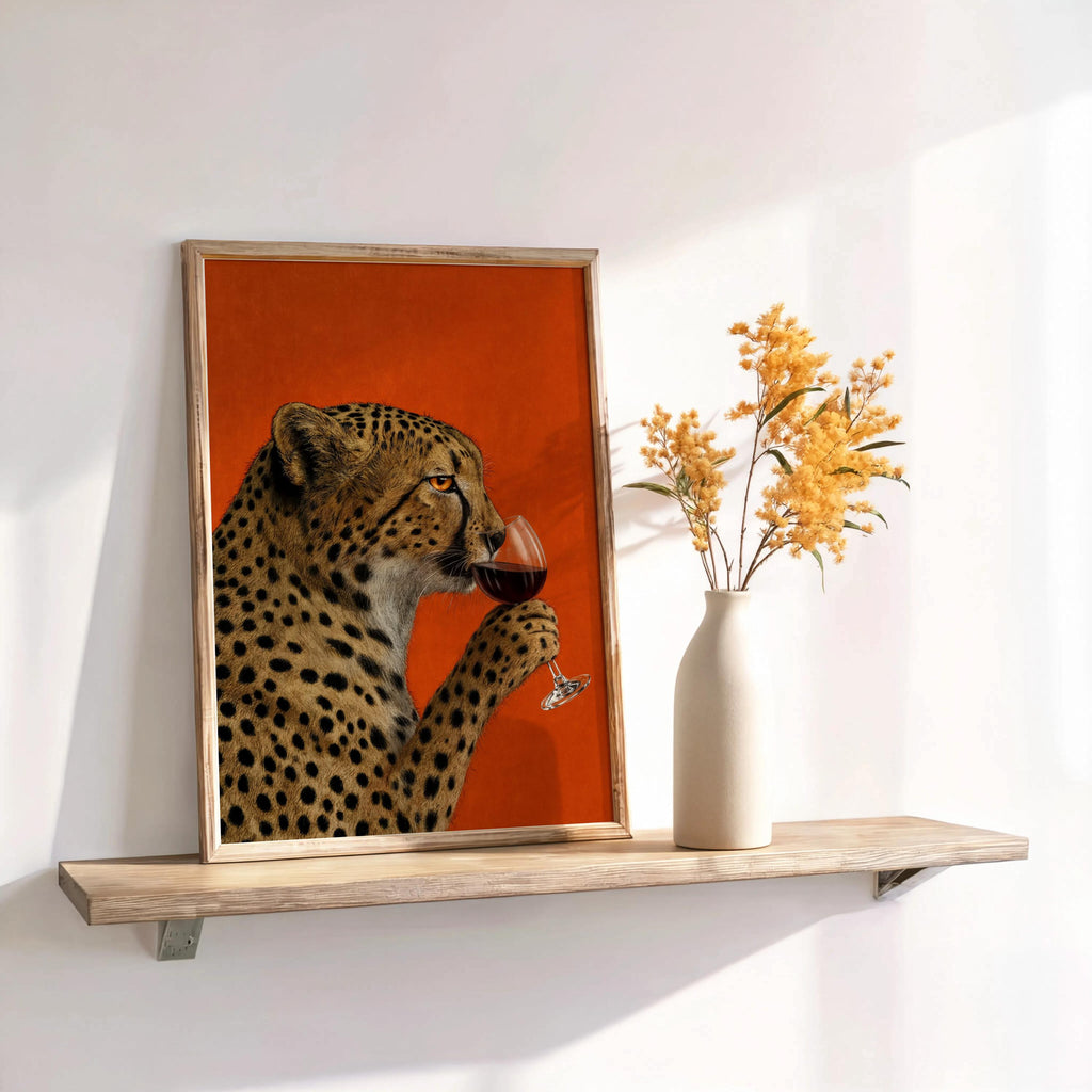 Cheetah drinking wine wall art leaning beside a white vase with yellow stems, bold red accent for eclectic interiors