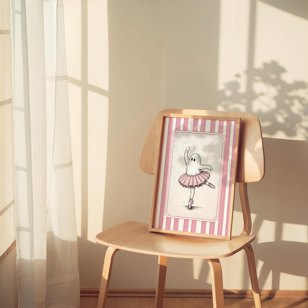 Framed ballerina ghost poster perched on a chair in gentle morning light, ballet nursery decor, vintage charm