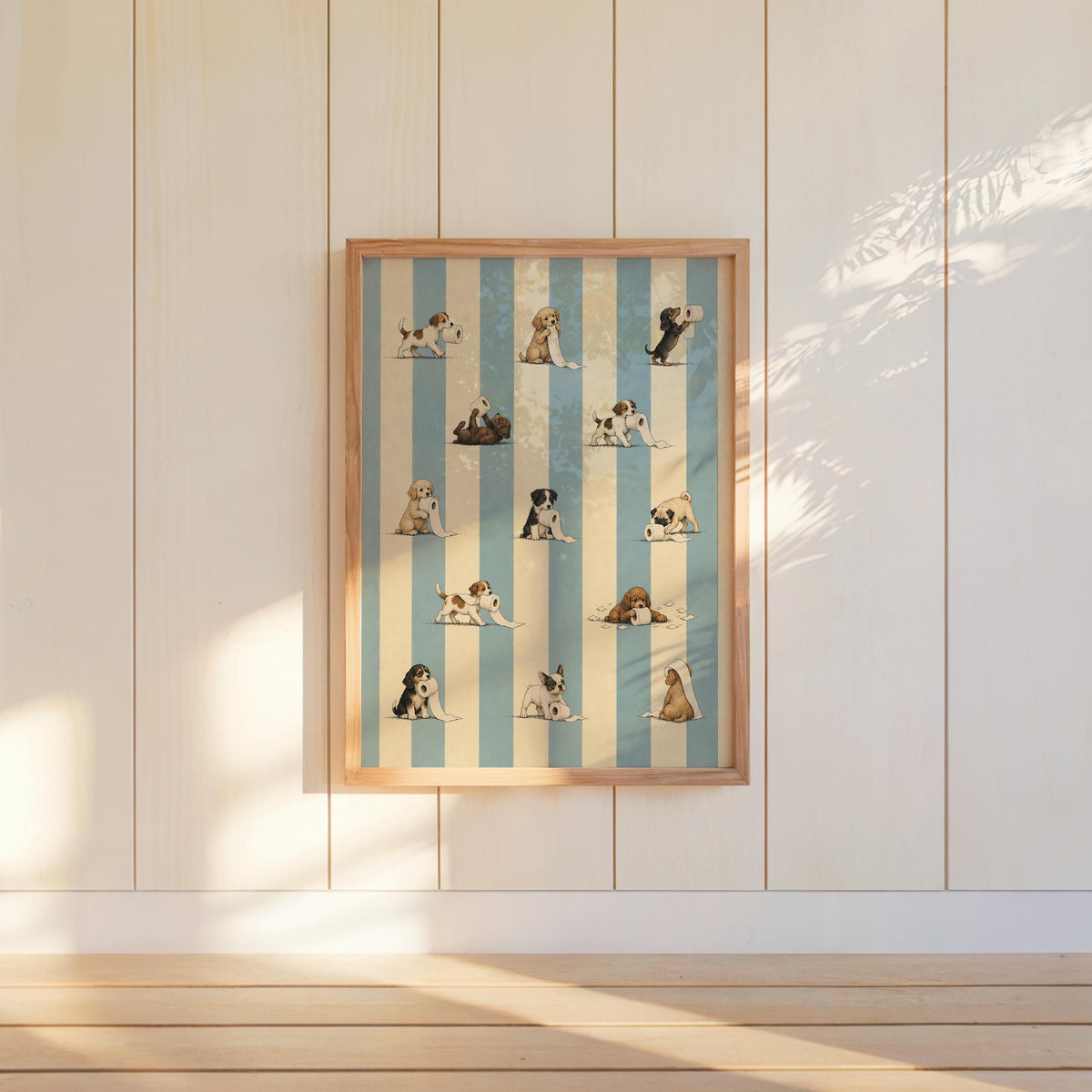 Wall-hung framed print on cream paneling, sunlight on mischievous puppies and blue stripes, funny dog bathroom wall art