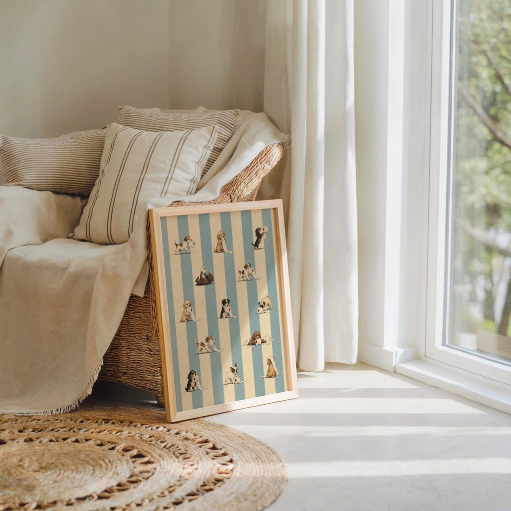 Two prints stacked by a cozy chair, quirky puppy scenes on vertical blue stripes, funny dog bathroom wall art