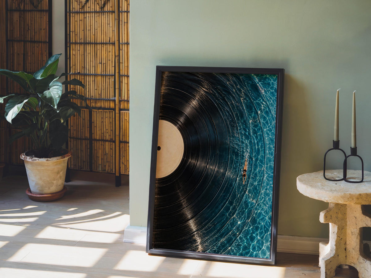 Framed vinyl record wall art leaning against a green wall, potted plant and warm light, vinyl record poster look