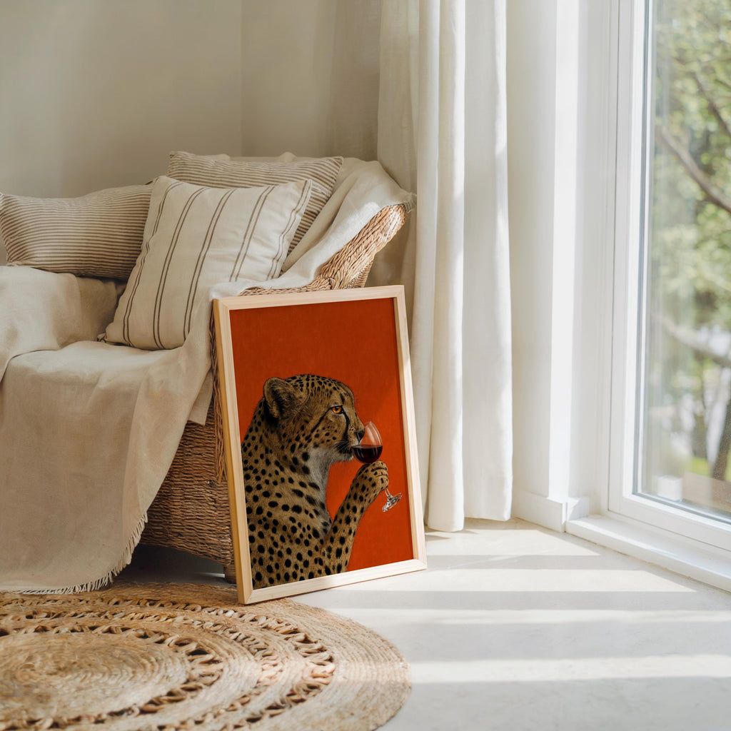 Cheetah drinking wine wall art beside a cozy armchair and woven rug, wine lover wall decor with playful vintage charm