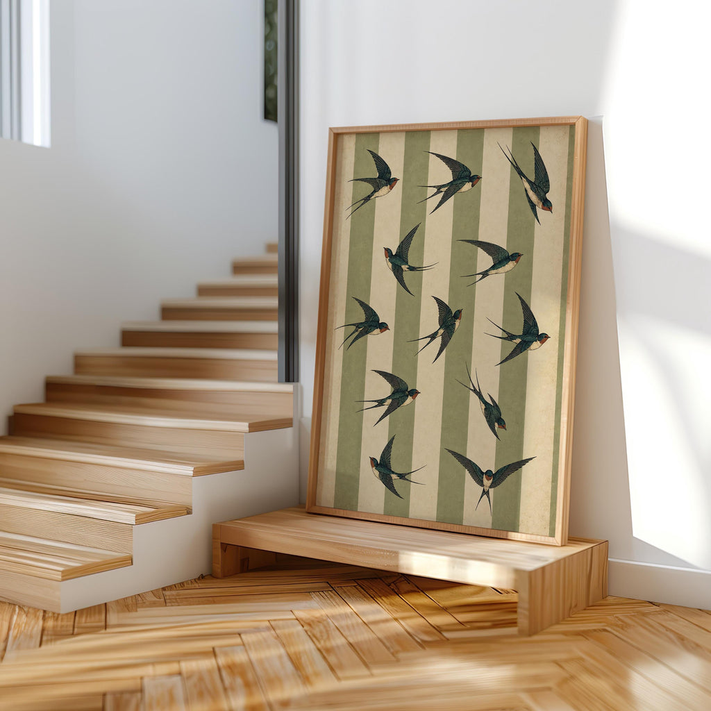 Swallow bird wall art leaning on wooden steps, sunlit vintage bird wall art for an ornithology inspired space