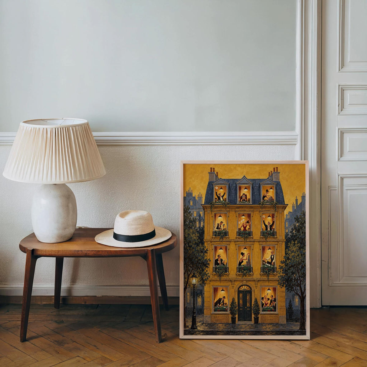Mustard print leaning on floor by console table, lamp and hat nearby, poker night wall art