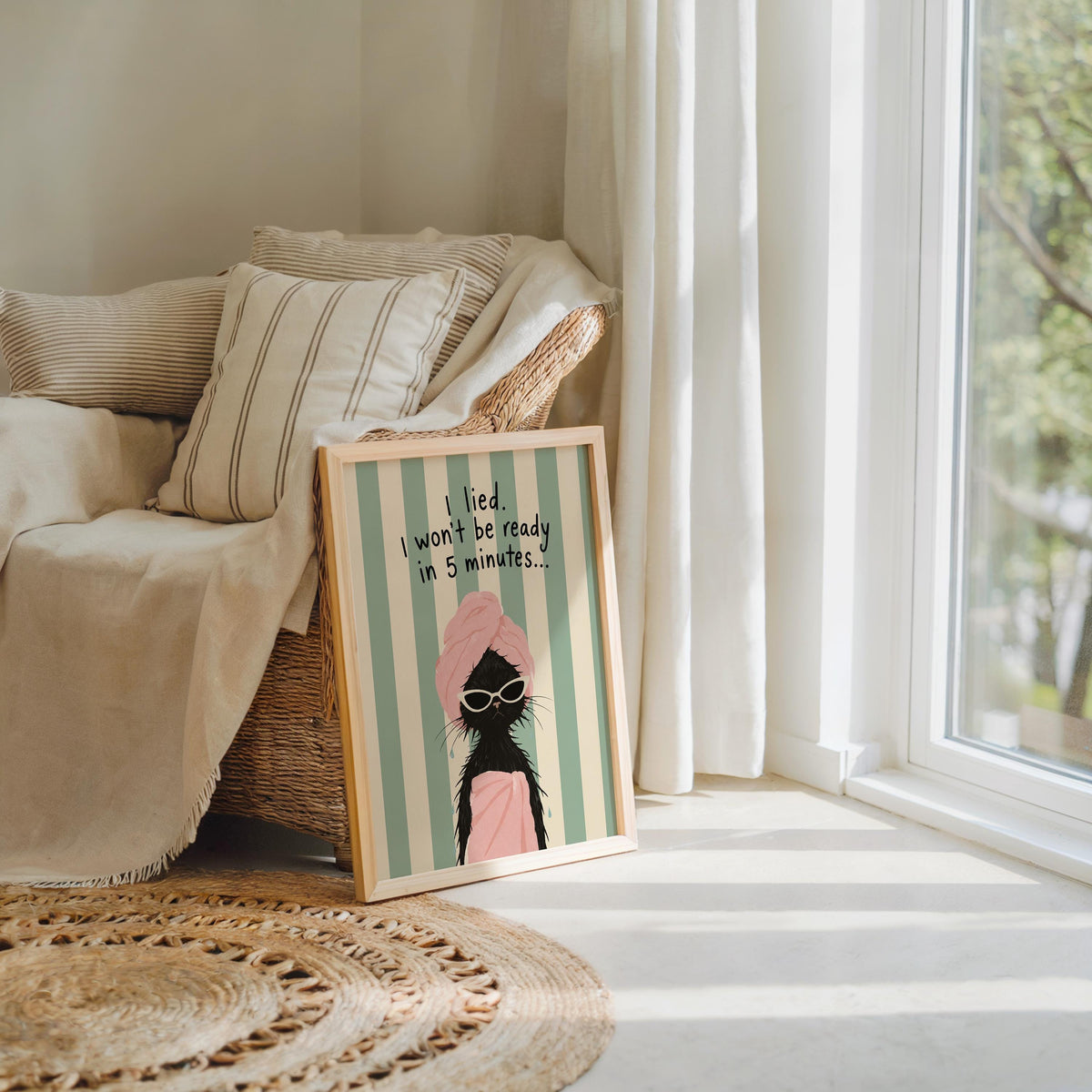 Unframed funny cat wall art propped by a cozy sofa, textured rug, mint stripes and oversized sunglasses