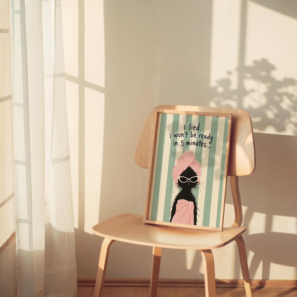 Quirky framed print perched on a wooden chair, mint stripes, white sunglasses on a drenched black cat