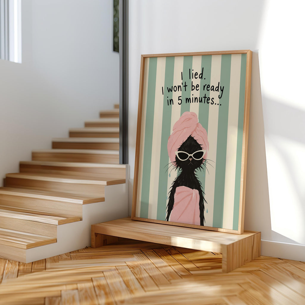 Unframed black cat art print propped on wooden steps, natural light, retro mint stripes, quirky bathroom poster