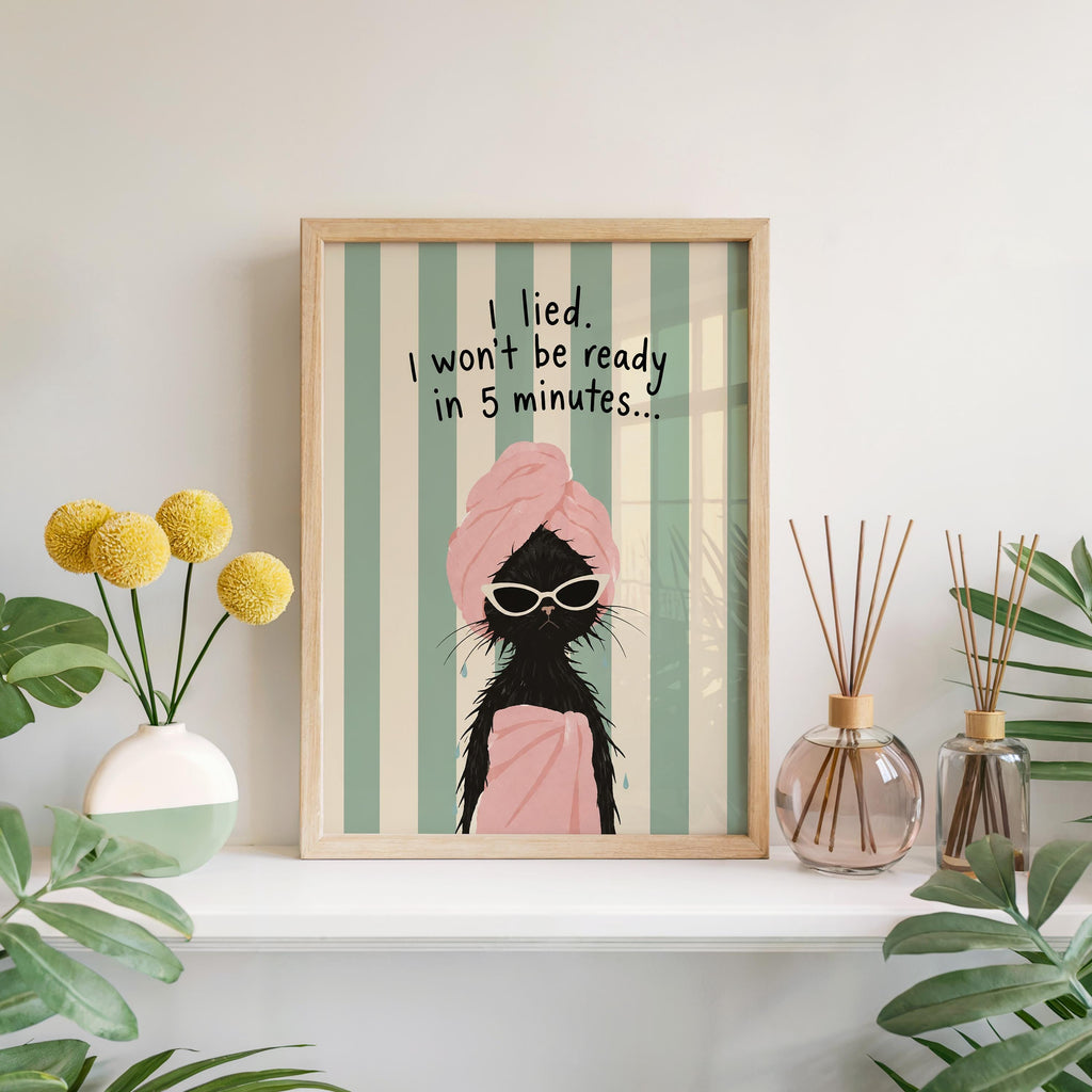 Black cat art print leaning on mantel, oversized white sunglasses, playful bathroom wall decor
