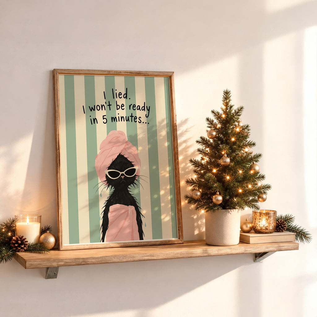 Seasonal display with funny black cat bathroom print on shelf, mini tree and warm candlelight, cozy gift idea