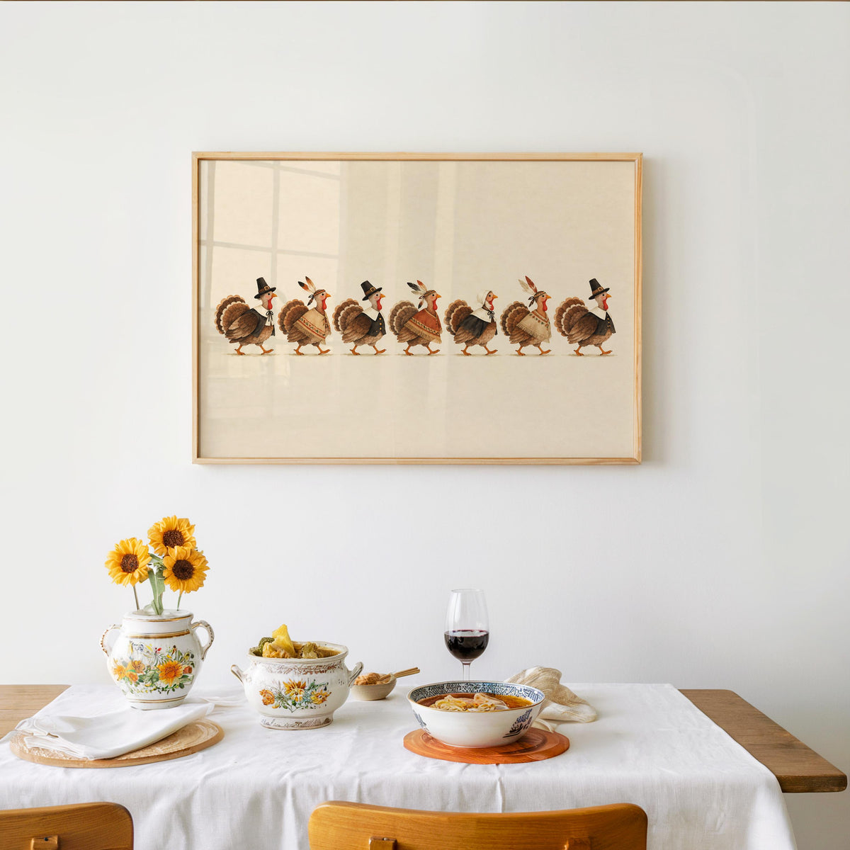 Festive table set below framed funny Thanksgiving wall art, charming scene ideal as a Thanksgiving host gift