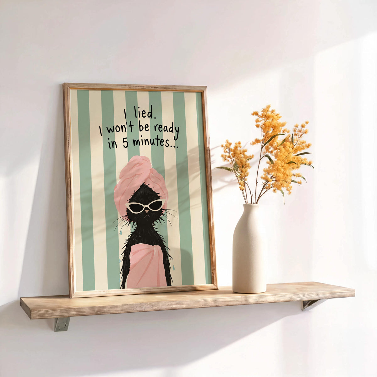 Playful funny cat wall art framed on floating shelf, pink towel cat, mint and cream stripes