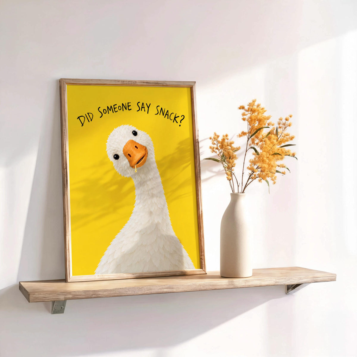 Angled unframed did someone say snack print on a shelf next to a vase, quirky animal art for pantry decor