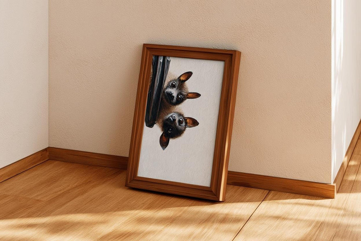 Fruit bat art print propped in a corner on hardwood, beige wall and cozy, quirky gothic charm
