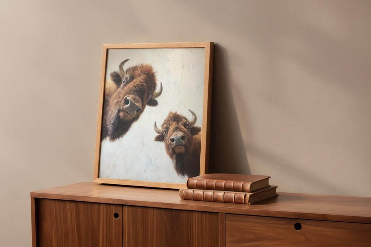 Bison wall art propped on wooden sideboard, warm light, neutral animal wall art styling