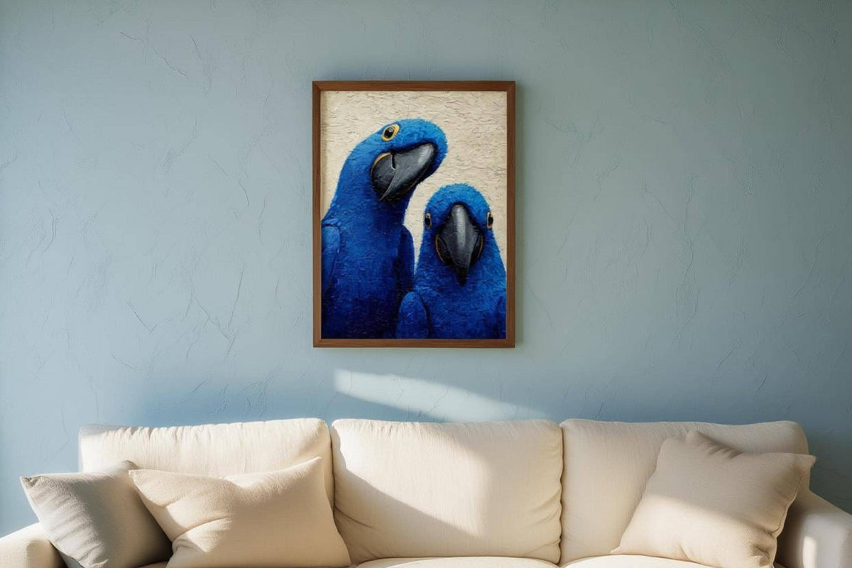 Smaller framed blue macaw wall art hung above a cream sofa, shows scale and tropical bird art print vibe