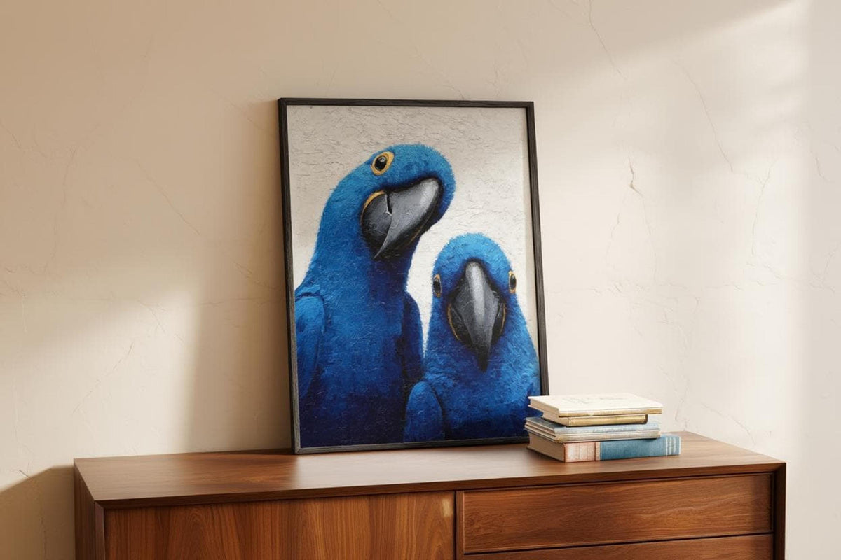 Blue macaw wall art leaning on a console, soft window light and a couple of books accent the scene