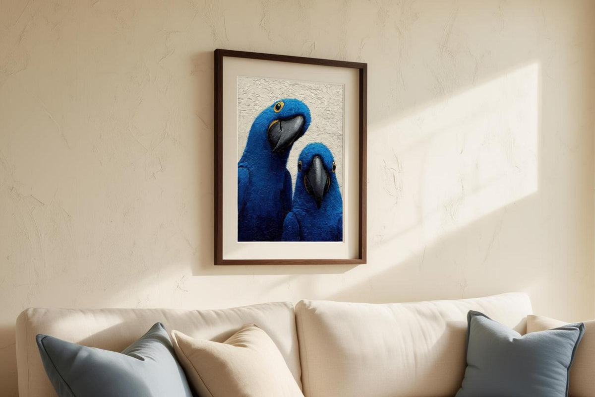 Framed blue macaw wall art above a couch with neutral pillows, warm afternoon light highlights texture