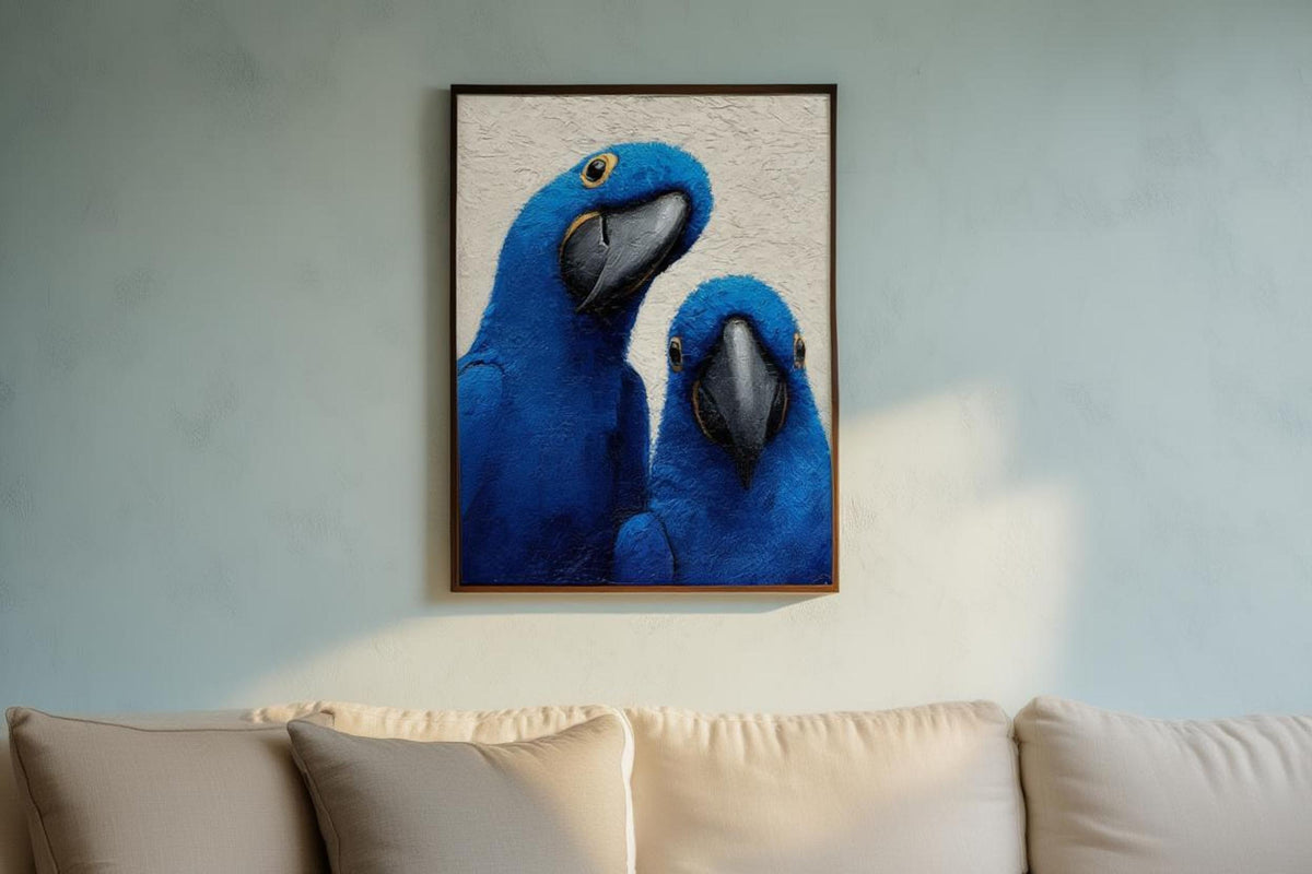 Blue macaw wall art hung above a sofa, cool blue wall lets the cobalt and indigo parrot colors pop