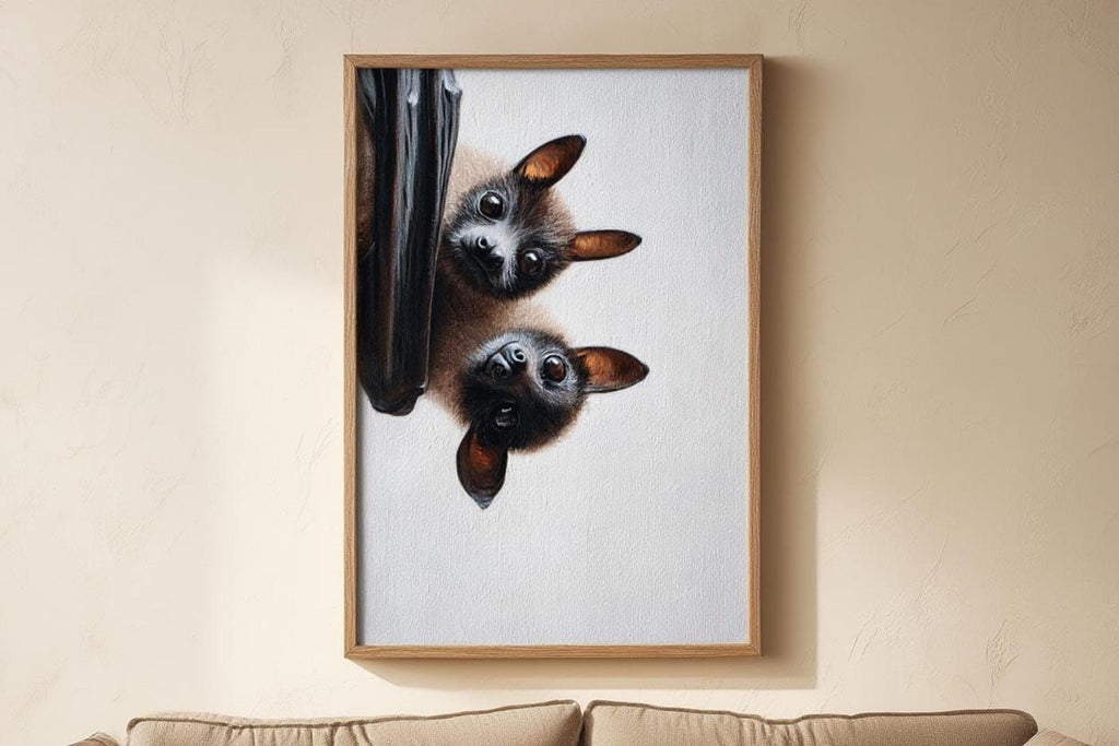 Vertical bat wall art print hung on cream wall, close crop showing curious large bat eyes