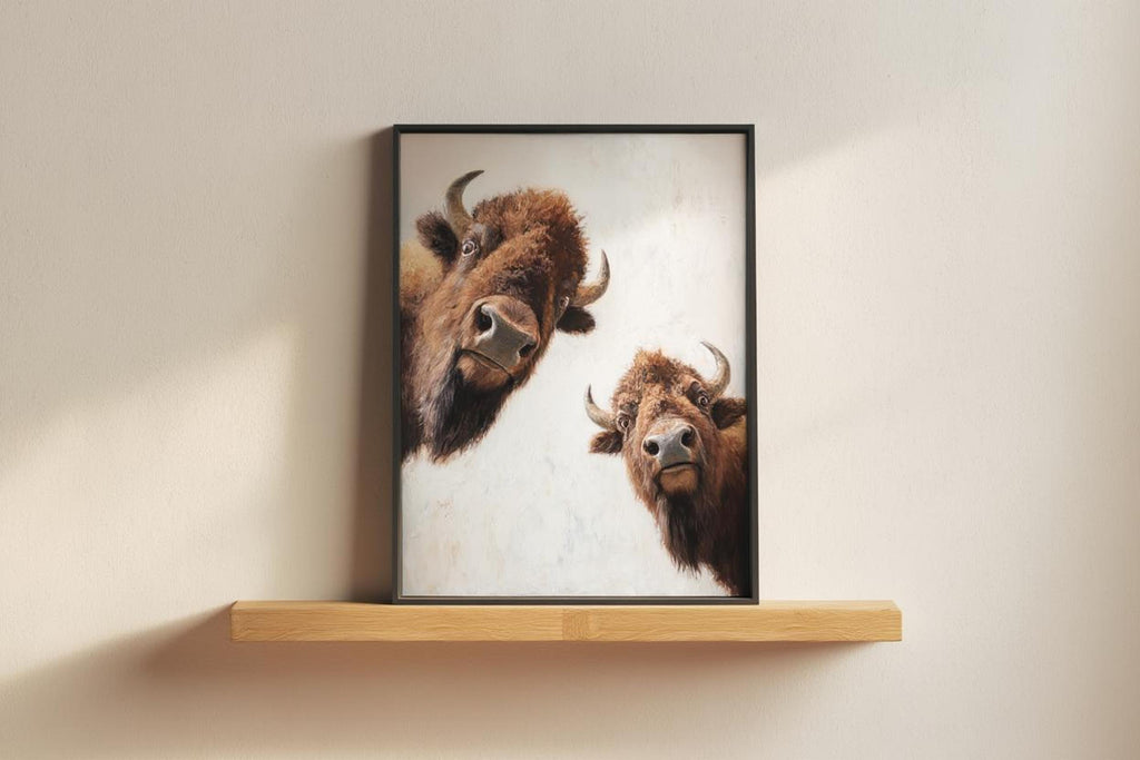 Framed bison art on shelf against pale wall, peeking bison print with soft painterly texture