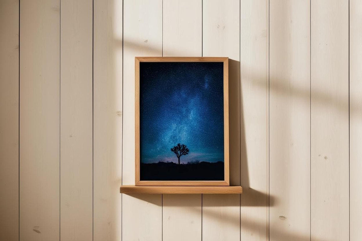Small framed Joshua Tree Milky Way wall art perched on a narrow shelf, warm wood paneling and soft sunlight