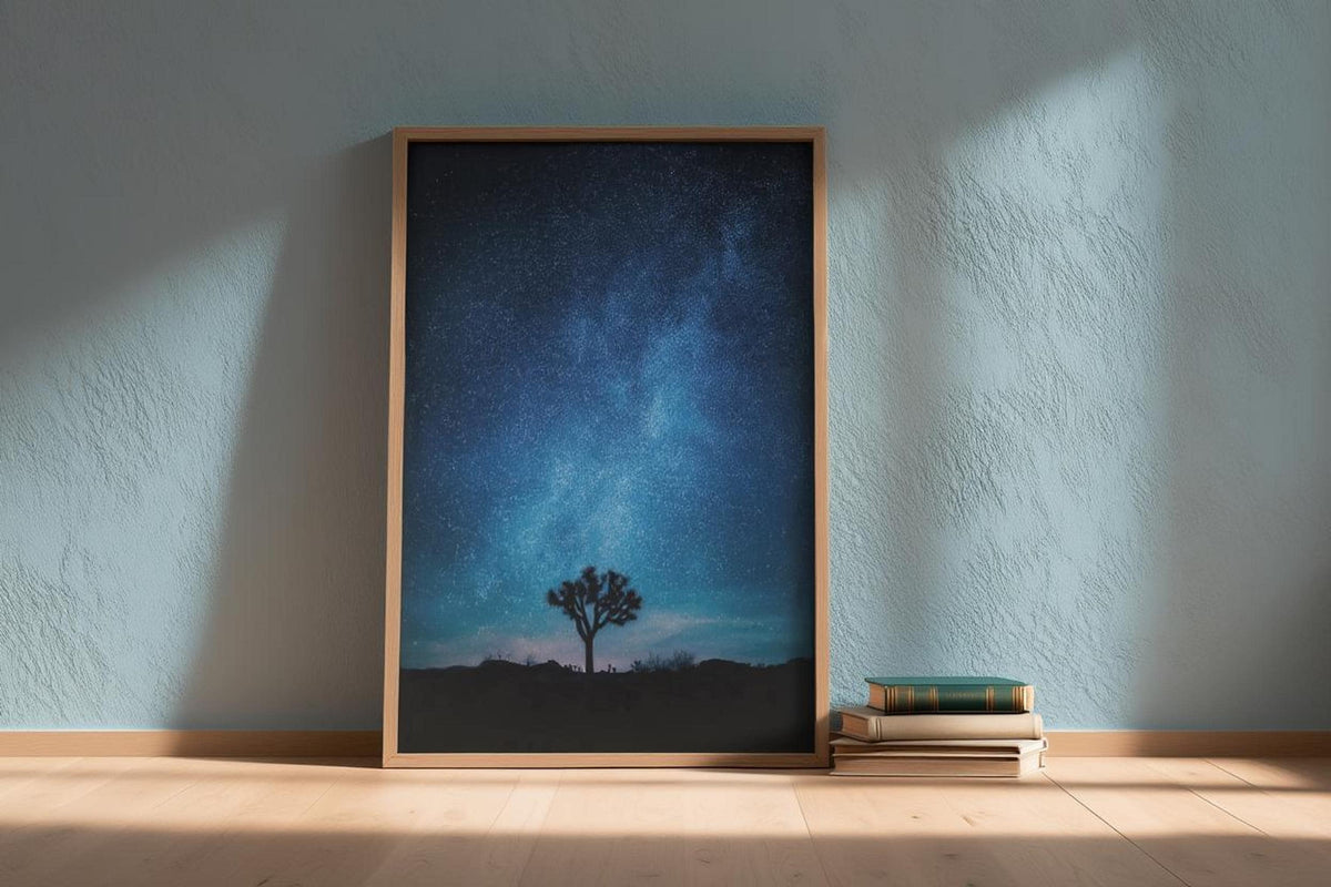 Framed Joshua Tree Milky Way wall art leaning against pale blue wall, celestial landscape art with soft light